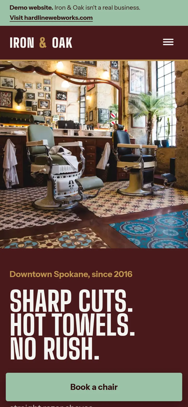 Iron & Oak Barbershop demo website on a phone